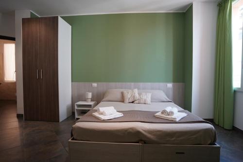 a bedroom with a bed with two towels on it at Bnbook Residence Matteotti in Novara