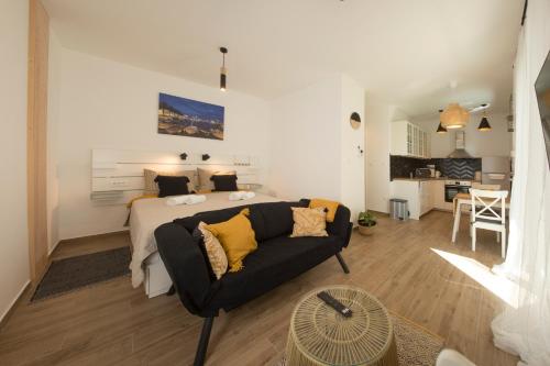 a living room with a bed and a couch at Studio and hot tub in Split