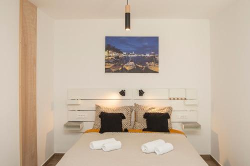 a bedroom with a large bed with two pillows at Studio and hot tub in Split