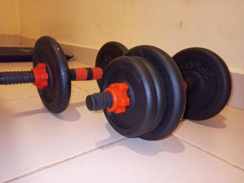 two black and red dumbbells on a wall at Beach View Hotel - Kisumu in Kisumu