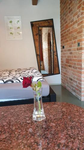 a vase with flowers on a table in a room at Ecitlav - ubytování Valtice in Valtice