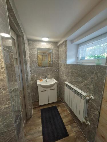 a bathroom with a sink and a mirror at Premium Terrace Apartament in Kraków