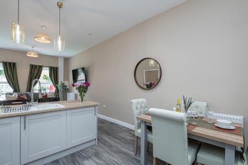 a kitchen and dining room with a table and a mirror at Finest Retreats - Peace Retreats Apartment, Pwllheli in Pwllheli