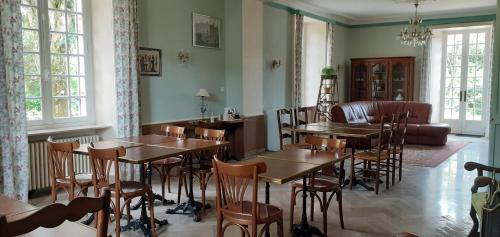 - un restaurant avec des tables, des chaises et un canapé dans l'établissement Château des Bretonnières sur vie - Maison d'hôtes et gîte 4 personnes, à Commequiers