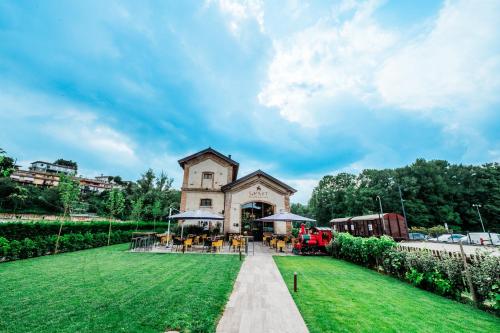 a building with a green lawn in front of it at SMART San Martino in Paratico