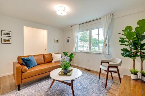 a living room with a couch and a table at Glen Cove Vacation Rental Less Than 1 Mi to Downtown! in Glen Cove