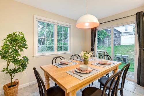 a dining room with a wooden table and chairs at Glen Cove Vacation Rental Less Than 1 Mi to Downtown! in Glen Cove