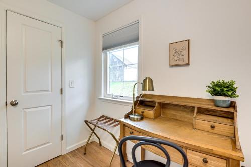a home office with a wooden desk and a window at Glen Cove Vacation Rental Less Than 1 Mi to Downtown! in Glen Cove