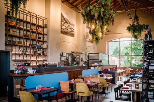 a restaurant with tables and chairs in a room at SMART San Martino in Paratico