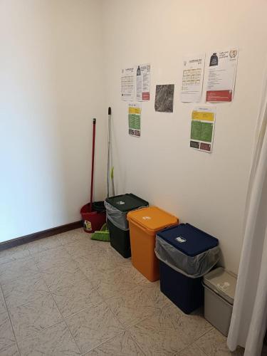 a room with four trash cans and posters on the wall at Casa Vacanze Lavanda & Rosmarino in Telve