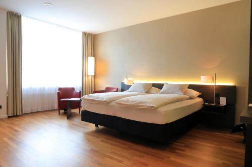 Postel nebo postele na pokoji v ubytování Hotel Banana City Winterthur
