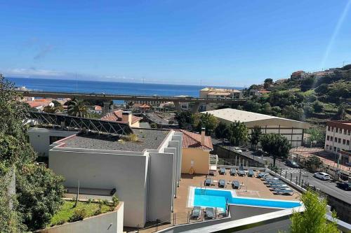 a view of a city with a swimming pool and the ocean at Ocean SC Apartment in Santa Cruz