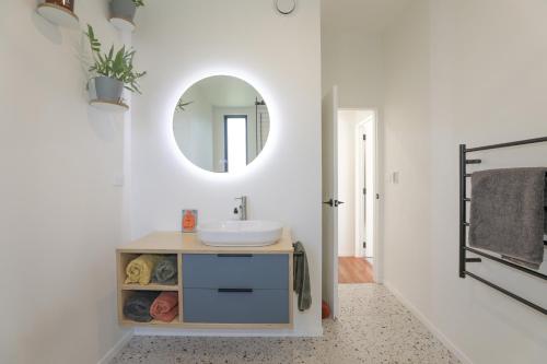 a bathroom with a sink and a mirror at Hannah's Bay Hideaway in Rotorua