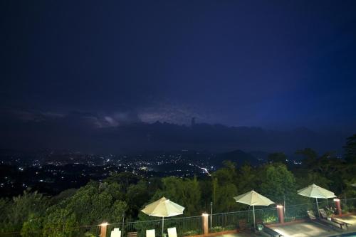 a view of a city at night with umbrellas at Amaya Hills Kandy in Kandy
