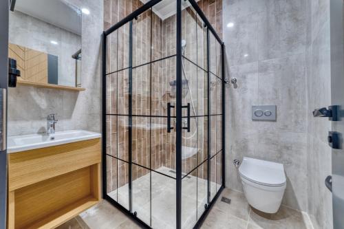 a bathroom with a toilet and a sink at Hildegard Hotel in Alanya