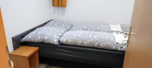 a black couch with pillows on it in a room at The Hostel in Hamburg
