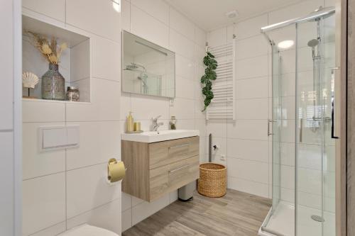 a white bathroom with a sink and a shower at 17, EnschedeCentrum in Enschede