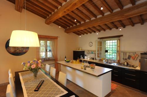a large kitchen with a table and a counter top at Villa Costa piccola with private pool in Umbria in Umbertide