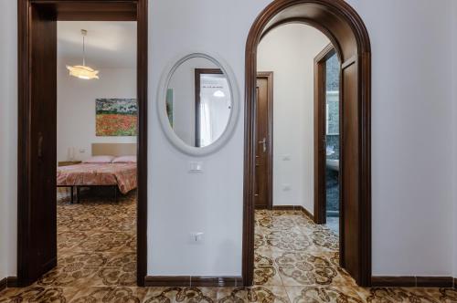 a hallway with a mirror and a bedroom at Cagliari Comfy Apartment with Terrace & Netflix! in Selargius