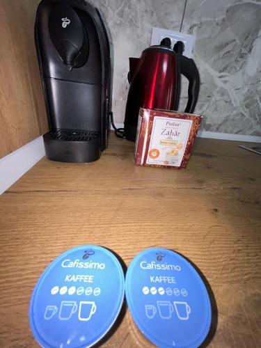 two blue plates on a table with a tea kettle at Cozy Aparthotel - Central City Suceava in Suceava