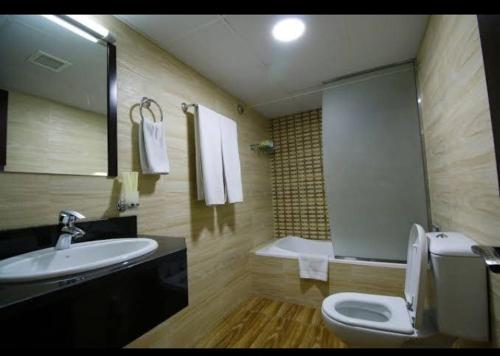 a bathroom with a sink and a toilet and a tub at comfort zone for accommodation in Dubai