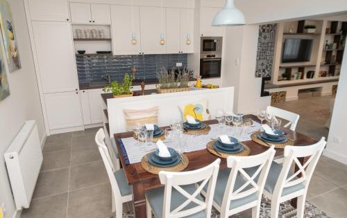 a kitchen and dining room with a table and chairs at Villa GreenTree - with Private Pool, close to Budapest in Budakalász