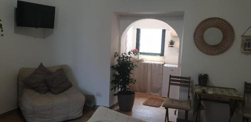 a living room with a couch and a table at IL GIARDINETTO di Dilyana in Monterosi