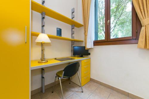 a room with a desk with a lamp and a chair at Isola di San Servolo - Centro Soggiorno in Venice