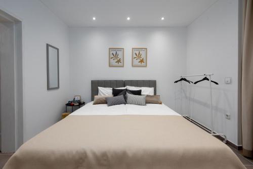 a bedroom with a large bed with white walls at Studio apartment Lu in Rupa