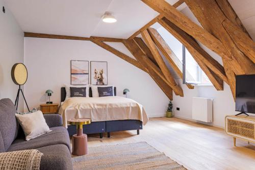 a bedroom with a bed in a room with wooden beams at Limehome Dachau Konrad-Adenauer-Str in Dachau