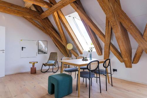 a dining room with a wooden table and chairs at Limehome Dachau Konrad-Adenauer-Str in Dachau