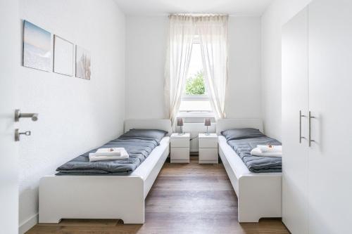 um quarto com duas camas e uma janela em Nice Apartment in Offenbach a. M. em Offenbach