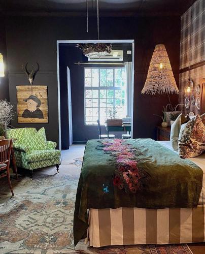 a bedroom with a bed and a chair and a window at The Hanover Luxury Hotel in Hanover