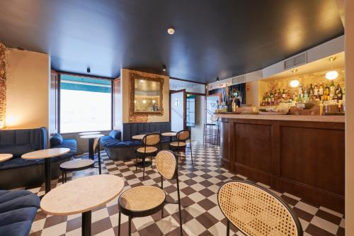a restaurant with tables and chairs and a bar at Casa do Mercado Lisboa in Lisbon