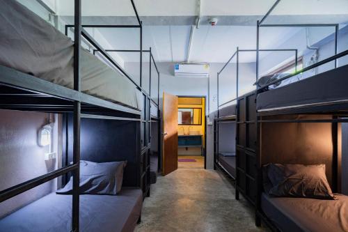 two bunk beds in a room with a hallway at Echo Hostel Koh Tao in Koh Tao