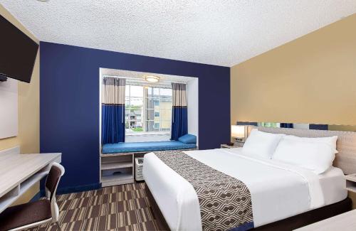 a hotel room with a bed and a window at Microtel Inn & Suites by Wyndham Dry Ridge in Dry Ridge