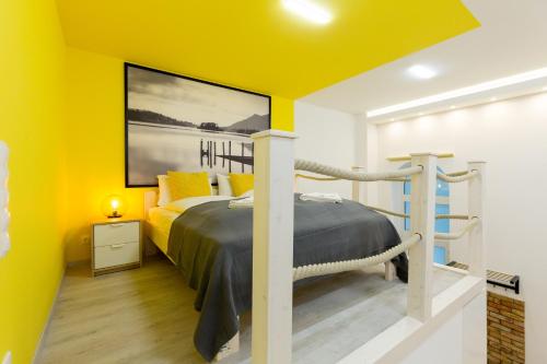 a bedroom with yellow walls and a bed at Pastel paradise with a ray of sunshine in Budapest