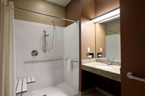 a bathroom with a shower and a sink at Microtel Inn & Suites by Wyndham St Clairsville - Wheeling in Saint Clairsville