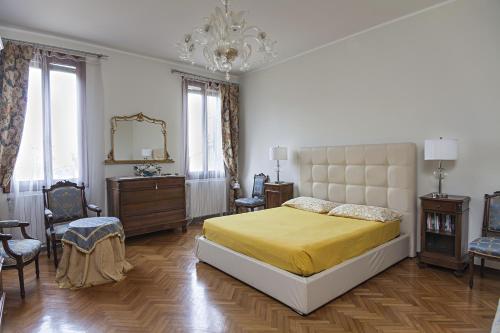 ein Schlafzimmer mit einem großen Bett und einem Kronleuchter in der Unterkunft Corte Stupenda in Venedig