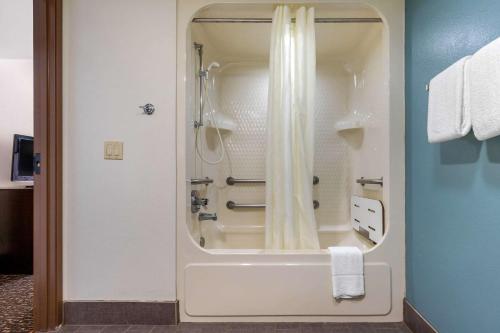 a bathroom with a shower with a shower curtain at Sleep Inn & Suites Johnson City in Johnson City