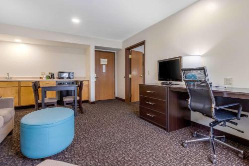 a hotel room with a desk and a chair and a computer at Sleep Inn & Suites in Johnson City