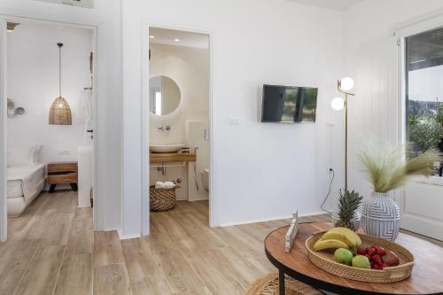 a bathroom with a table with a bowl of fruit at Arsenis Luxury Villas in Plaka
