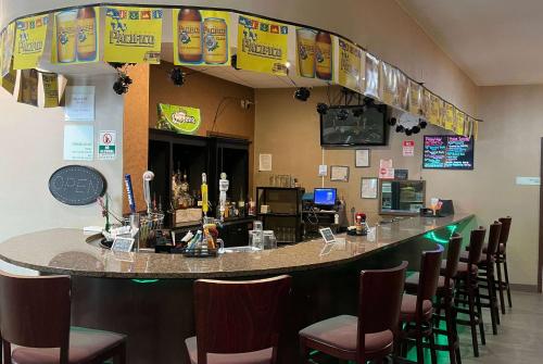 a bar in a restaurant with chairs around it at Wyndham Garden Dover in Dover