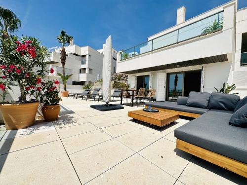 a patio with a couch and a table at Hermanas de Pulpi in San Juan de los Terreros