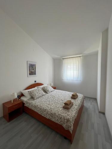 Postel nebo postele na pokoji v ubytování Apartmani Leskovar