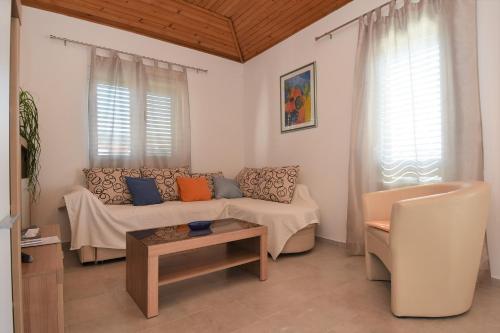 a living room with a couch and a table at Apartments Silvija near Luke beach in Murter