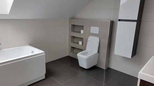 a small bathroom with a toilet and a sink at Southfork u Štěpánků - Apartmán Branišov 