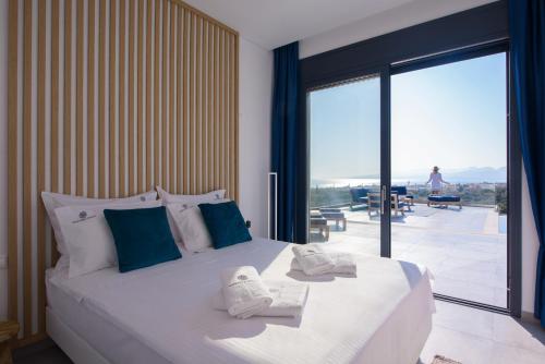 a bedroom with a large bed with towels on it at Kali Thea Villas in Hersonissos