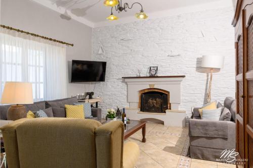 a living room with a couch and a fireplace at Siridaki Homes Leros in Agia Marina