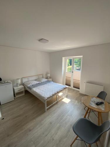 1 dormitorio con 1 cama, 1 mesa y 1 silla en ANNA CENTRUM-Pokoje przy plaży (ul.Nadbrzeżna 5), en Giżycko